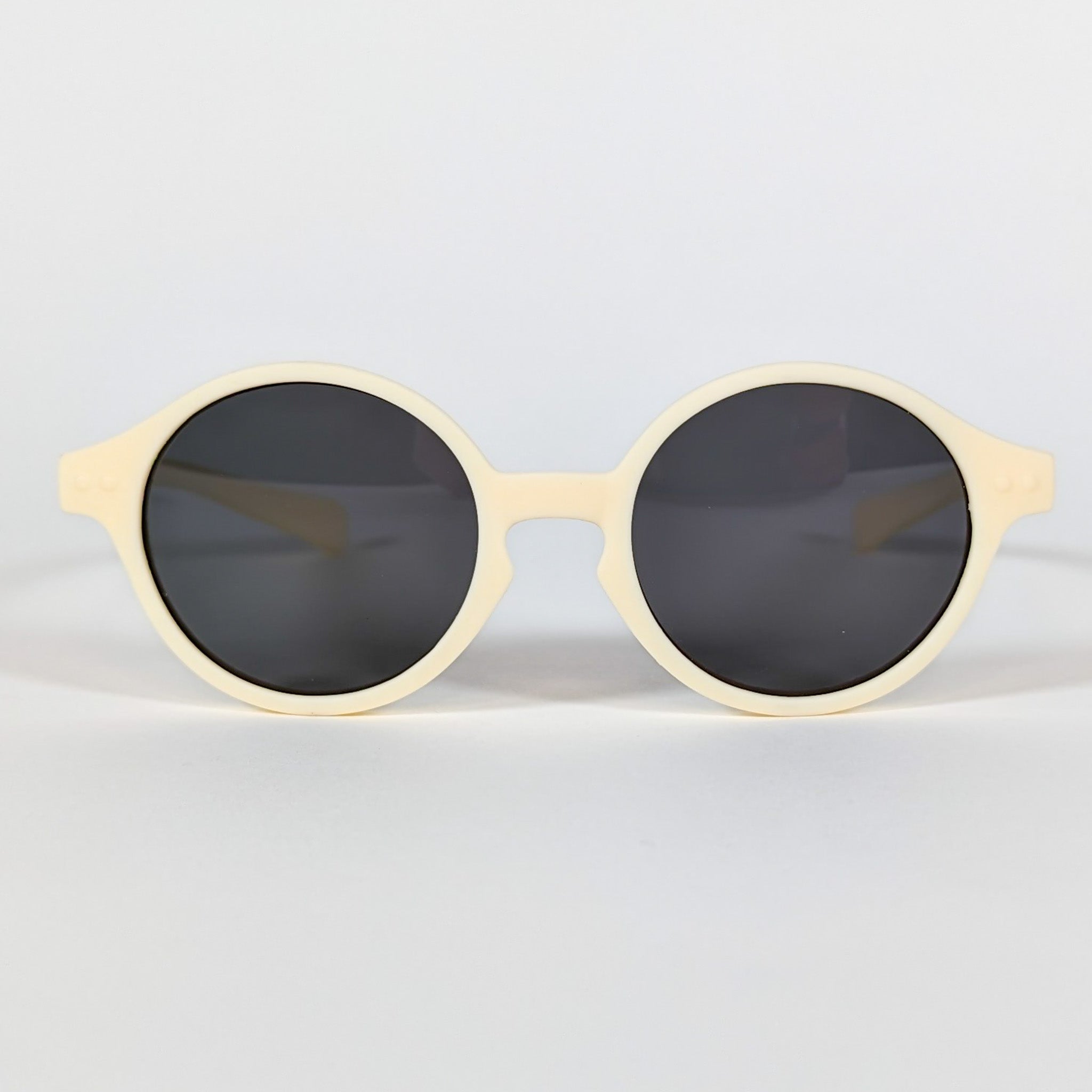 Zoomed in view of baby sunglasses with a yellow frame and round lenses.