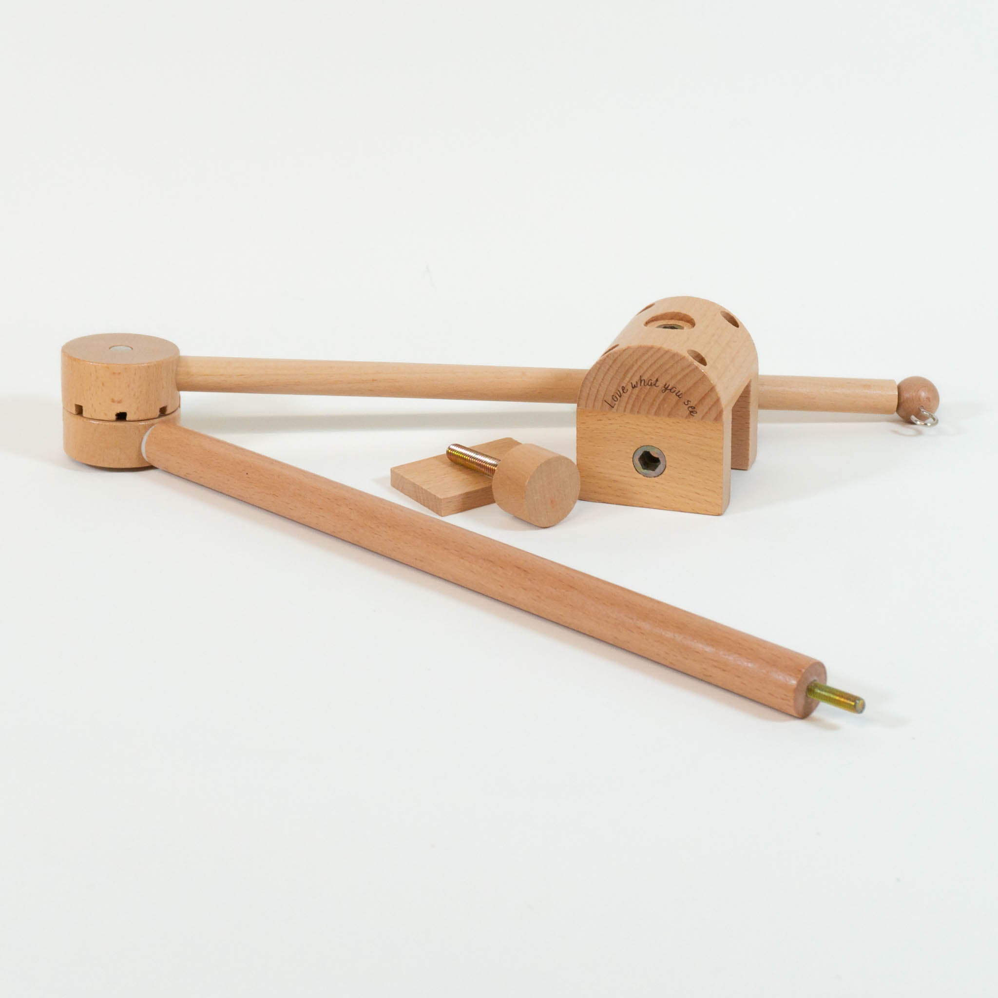 The components of a wooden mobile arm are laid out on a white background.