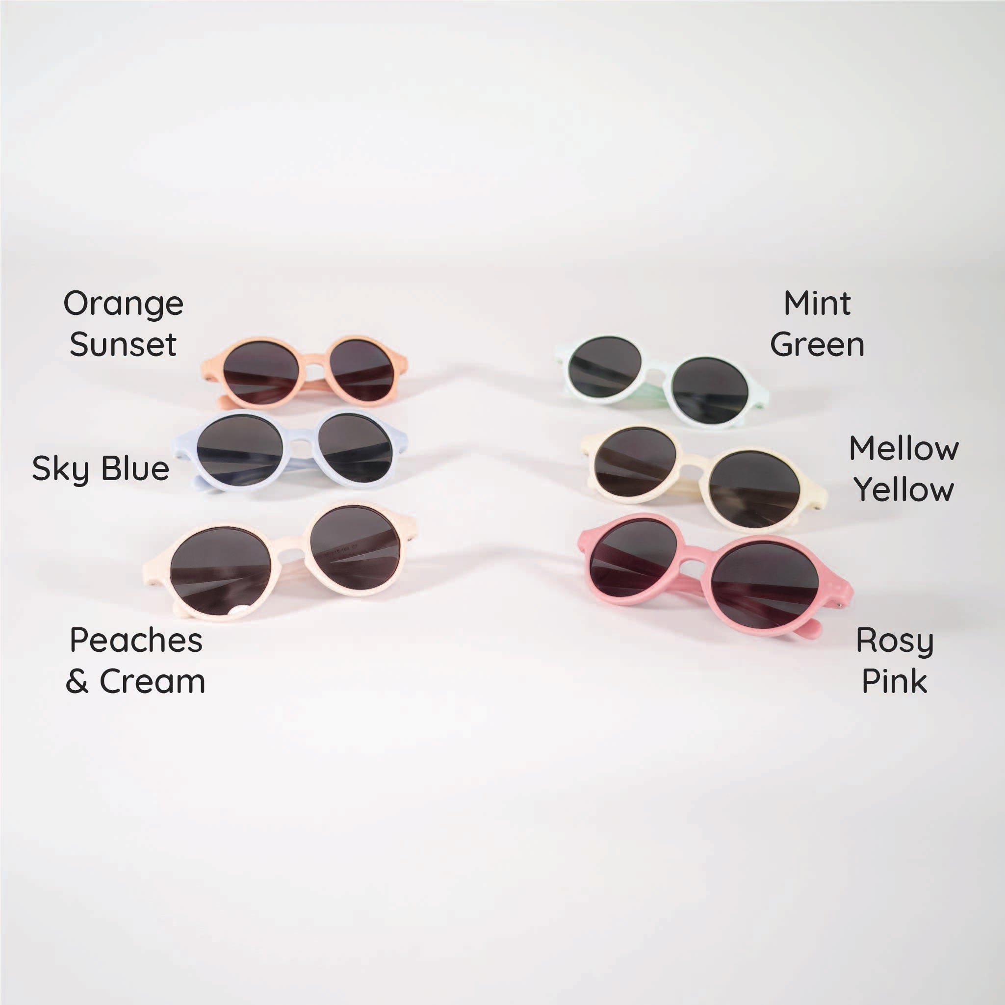 Six pairs of infant sunglasses displayed with color labels, including orange sunset, sky blue, peaches and cream, mint green, mellow yellow and rosy pink.