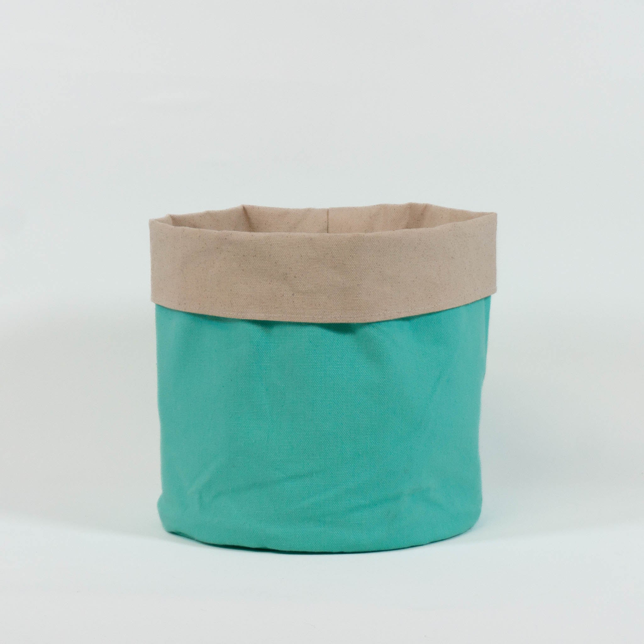 A cloth storage basket with mint green outside and beige inside.