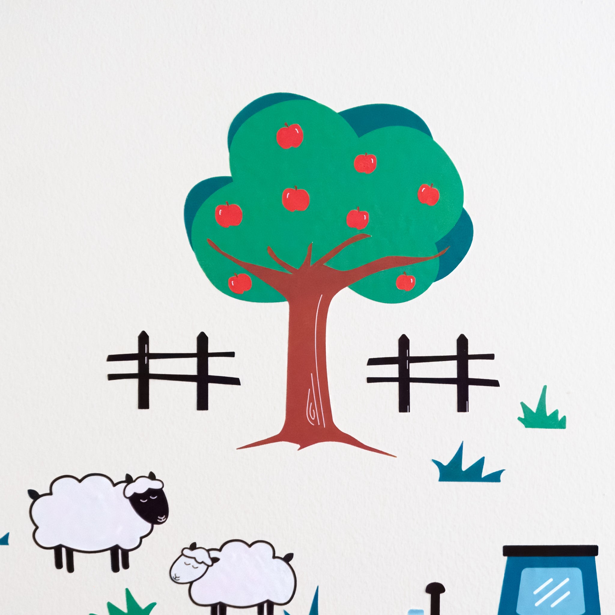 Close up of Smartbaby Decor's apple tree wall art with green leaves, brown trunk and 8 red apples. Surrounded by fences, grass and sheep wall decals.