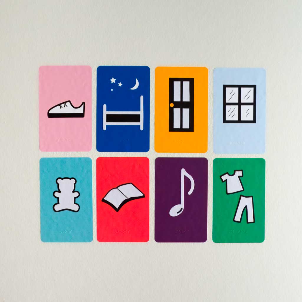 8 colorful wall decals each featuring a different room feature including a shoe, bed, door, window, teddy bear, book, music note, and clothes with braille