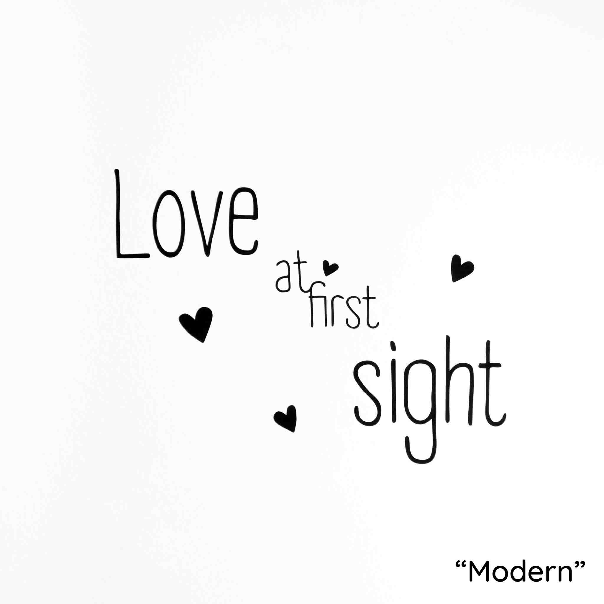 White background with phrase "Love at first sight" as a wall art decal in black modern font.